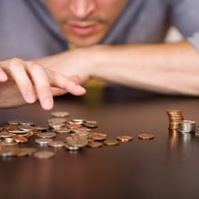 A person budgeting limited income to cover everyday expenses.