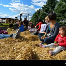 People seated on hay bales during a hayride.