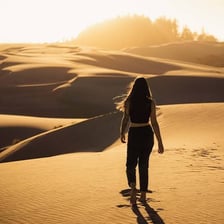 A person gazing thoughtfully at an appealing travel destination.