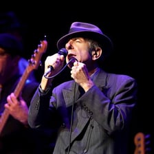 Leonard Cohen performing with a microphone.