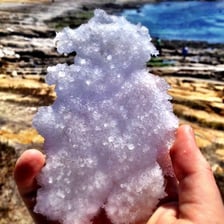 White sea salt crystals beside seawater