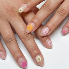 A close-up of fingers with decorative manicure art