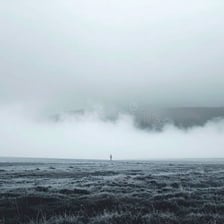 A dark, gloomy landscape under heavy clouds.