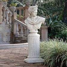 A sculpted bust displayed on a raised pedestal.