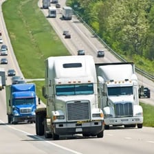 A semi-truck driving on a highway.
