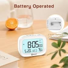 AAA batteries placed beside a small alarm clock