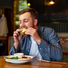 A person eating food at a table.