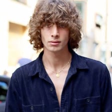 A person with thick, tousled hair.