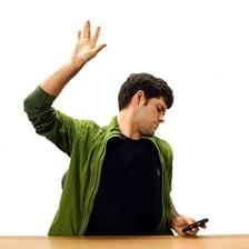 A person raising a hand to indicate it is their turn