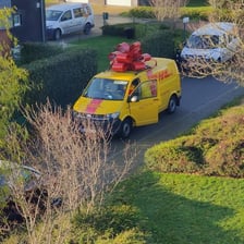 A DHL delivery van in the company's red-and-yellow colors.