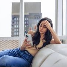 An exhausted person leaning back in a chair