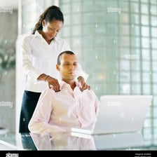A person massaging another person's shoulders.
