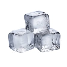 An ice cube melting into water droplets