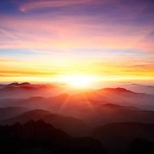 The sun coming up over the horizon