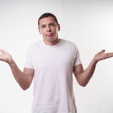 A person shrugging with an unimpressed expression