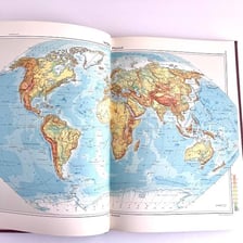 An open atlas displaying geographic maps