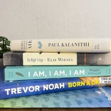 Several books of personal memoirs arranged on a desk