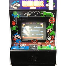 An arcade or game-screen depiction of the 1983 Mario Bros. video game.