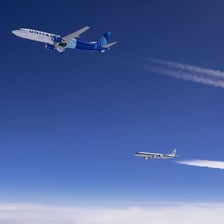 A jet leaving a white contrail across the sky
