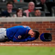A baseball rising high into the sky after being hit