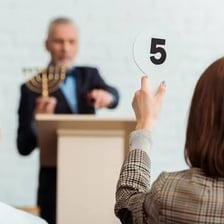 An auctioneer opening a bid with an initial price