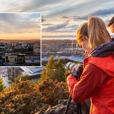 A photographer framing a scene from a chosen angle