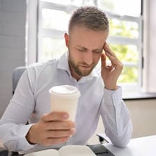 An energetic person holding a cup of coffee