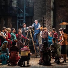 Actors performing a serious scene on stage