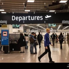A traveler departing through an airport terminal