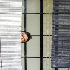 A person concealed behind a curtain
