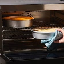 A cake baking in an oven.