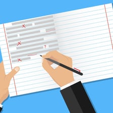 A person correcting a mistake on a sheet of paper