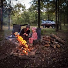A campfire burning at an outdoor campsite