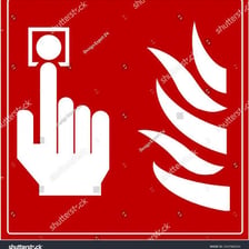 A hand pressing a fire alarm button