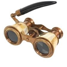 A pair of compact decorative opera glasses used in a theater.