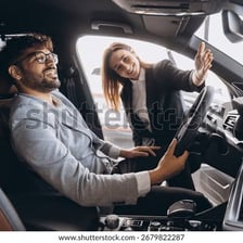 A driver testing a car on the road