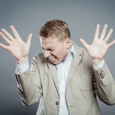A person raising both hands in surrender