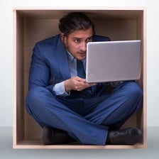 A person moving cautiously and slowly through a narrow space