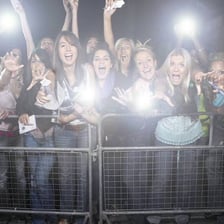 An enthusiastic fan cheering at a concert