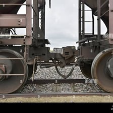Two train cars linked by a coupling.