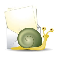 A snail pictured beside a sealed postal envelope.