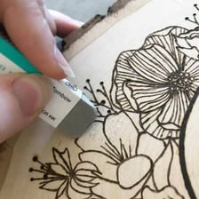 An eraser removing pencil marks from a sheet of paper.