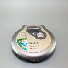 A compact disc beside a portable CD player.