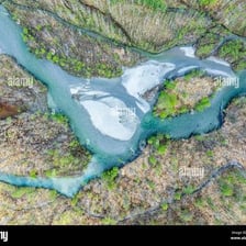 An aerial view of a river dividing into a smaller arm