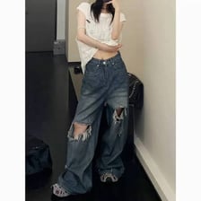 A pair of jeans with visible ripped openings