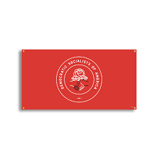 A political rally featuring a Democratic Socialists of America sign