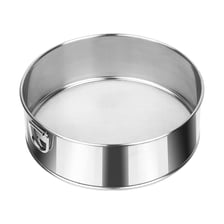 A kitchen sieve being used to sift flour