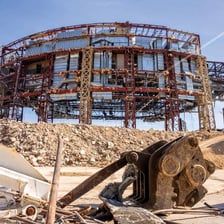 A building being demolished into rubble