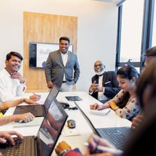 A person at the front of a group directing others