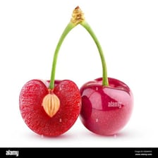 A halved cherry with its hard pit visible.